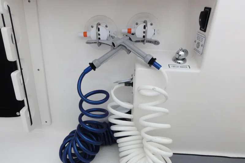  Yacht Photos Pics 2024 Pursuit S 328 Sport boat with coiled hoses and fresh water outlet.