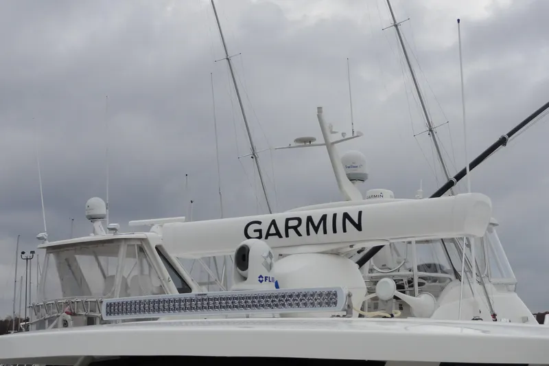  Yacht Photos Pics 2024 Pursuit S 328 Sport boat with Garmin equipment under cloudy sky.