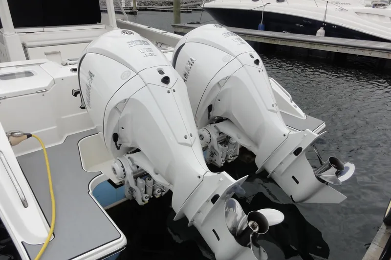  Yacht Photos Pics 2024 Pursuit S 328 Sport boat with dual outboard engines docked.