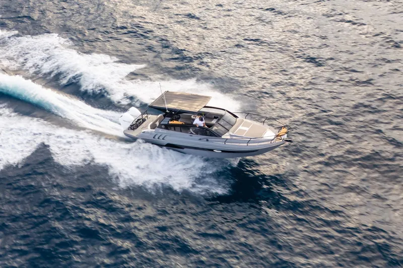  Yacht Photos Pics Aerial view of 2026 Hanover 305 speedboat cruising on open water.