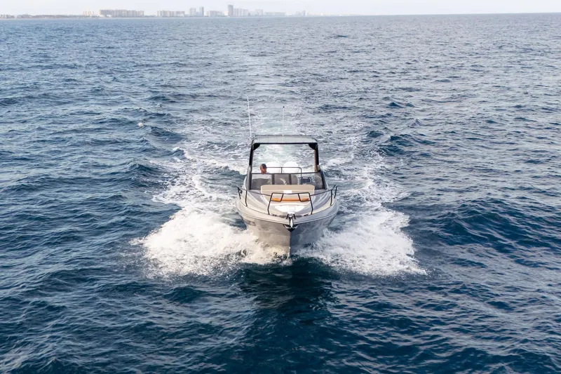  Yacht Photos Pics 2026 Hanover 305 boat cruising on open ocean waters.