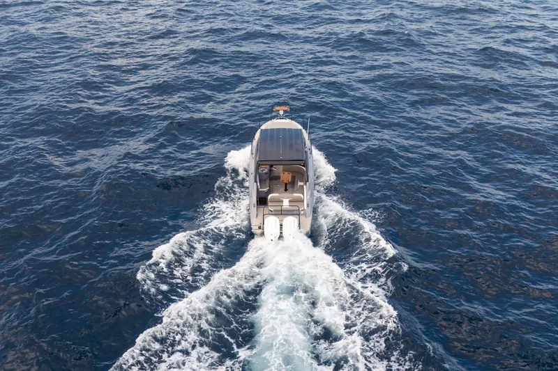  Yacht Photos Pics Aerial view of 2026 Hanover 305 boat cruising on open water.