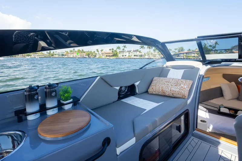  Yacht Photos Pics Luxurious Hanover 305 boat interior, 2026 model, featuring elegant seating and scenic waterfront view.