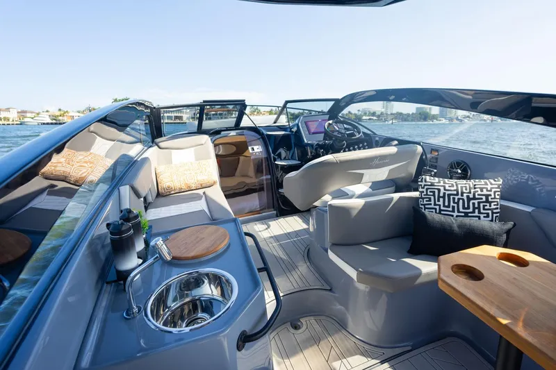  Yacht Photos Pics Luxurious 2026 Hanover 305 boat interior with modern seating, sink, and scenic water view.