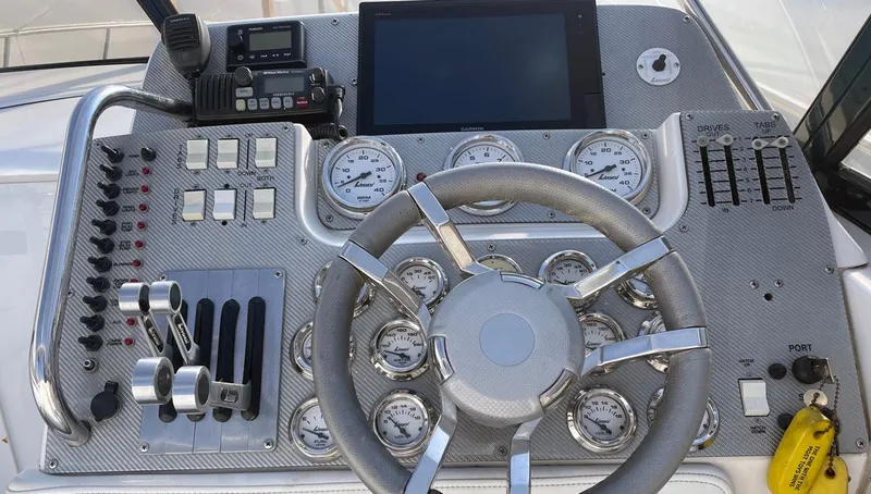  Yacht Photos Pics Control panel of a 2002 Fountain 38 Express Cruiser with gauges and steering wheel.