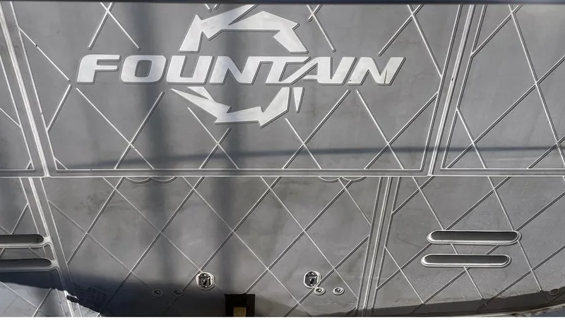  Yacht Photos Pics 2002 Fountain 38 Express Cruiser boat deck with logo and geometric pattern.