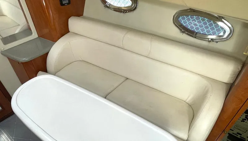  Yacht Photos Pics Interior of 2002 Fountain 38 Express Cruiser with beige seating and oval windows.