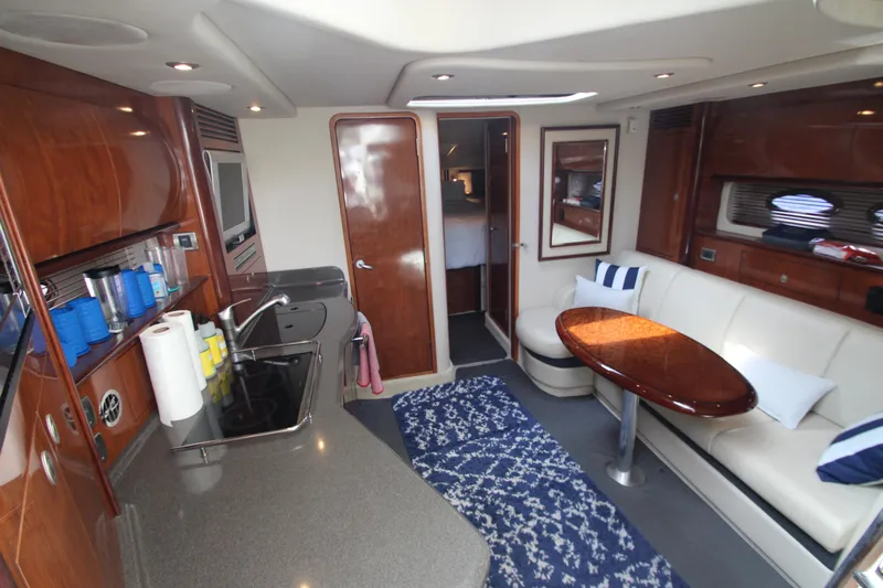  Yacht Photos Pics Luxurious interior of 2004 Sea Ray 40 Sundancer yacht with modern kitchen and seating area.