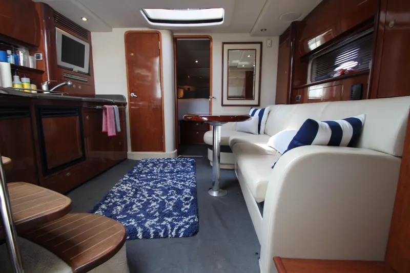  Yacht Photos Pics Interior of 2004 Sea Ray 40 Sundancer yacht with modern furnishings and cozy seating area.