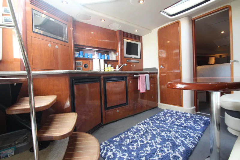  Yacht Photos Pics Interior of 2004 Sea Ray 40 Sundancer yacht with kitchen and seating area.