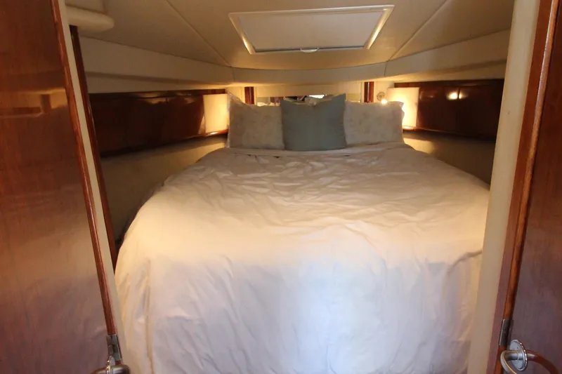  Yacht Photos Pics Luxurious cabin interior of 2004 Sea Ray 40 Sundancer yacht with cozy bedding.