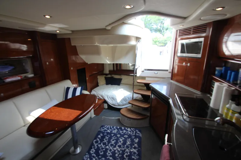  Yacht Photos Pics Luxurious interior of 2004 Sea Ray 40 Sundancer yacht with modern amenities and cozy seating.