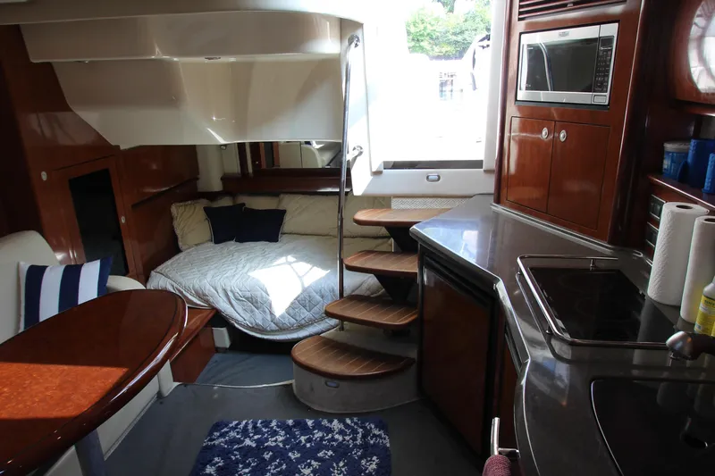  Yacht Photos Pics Luxurious interior of 2004 Sea Ray 40 Sundancer yacht with cozy bed and modern kitchen.