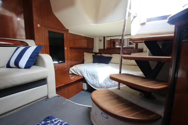  Yacht Photos Pics Interior of 2004 Sea Ray 40 Sundancer yacht with cozy bed and wooden stairs.