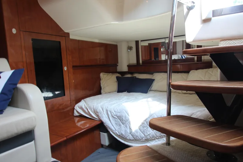  Yacht Photos Pics Luxurious interior of 2004 Sea Ray 40 Sundancer yacht with cozy bed and wooden stairs.