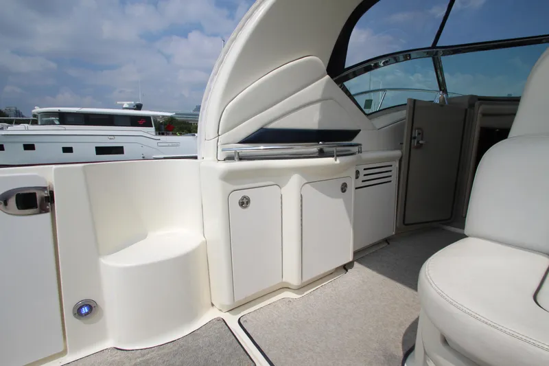  Yacht Photos Pics 2004 Sea Ray 40 Sundancer yacht interior with seating and storage, under a clear sky.