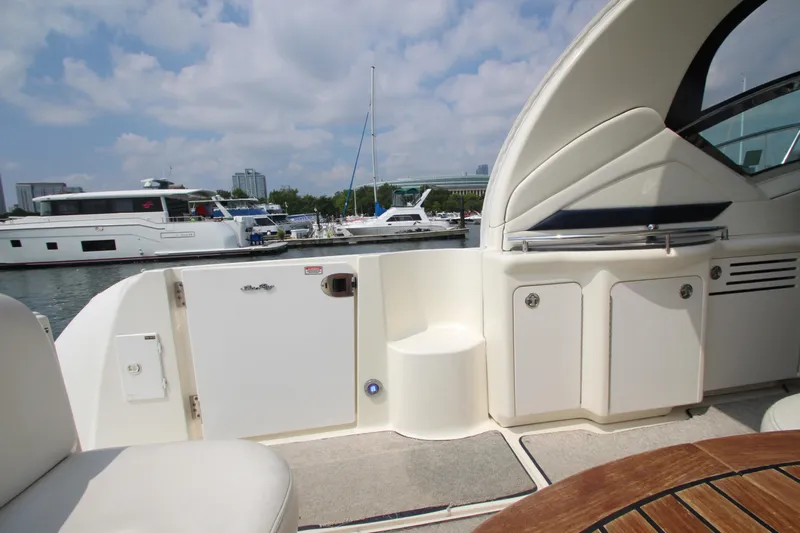 Yacht Photos Pics 2004 Sea Ray 40 Sundancer yacht interior with marina view, featuring seating and storage.