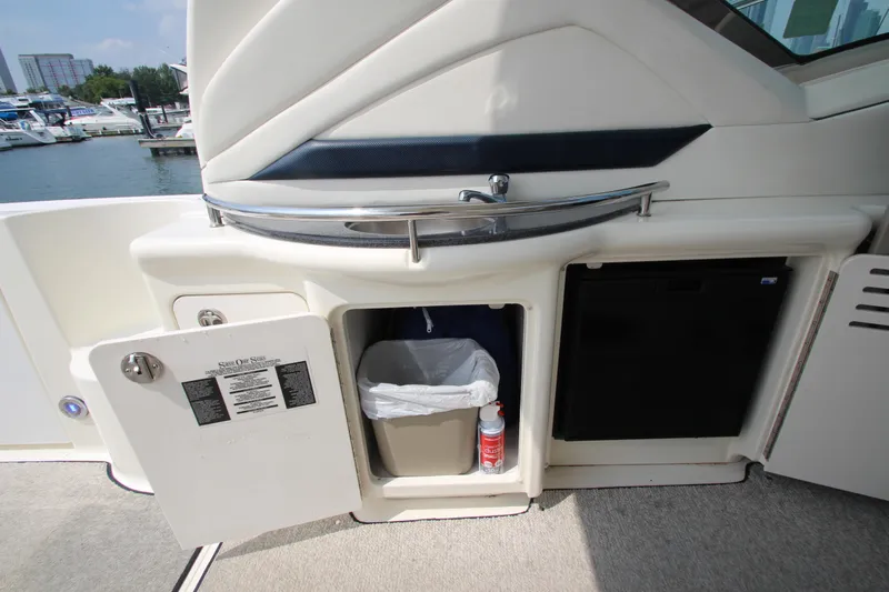  Yacht Photos Pics 2004 Sea Ray 40 Sundancer yacht interior with open storage compartment and mini fridge.