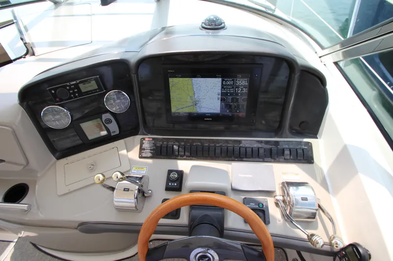  Yacht Photos Pics 2004 Sea Ray 40 Sundancer helm with navigation controls and steering wheel.