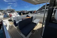 2021 Nimbus T11 T Top boat interior with seating and table, docked at marina.