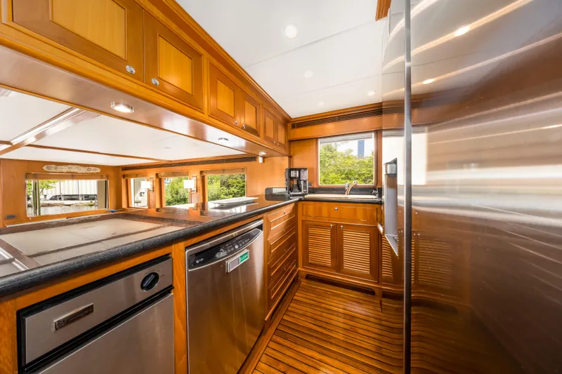 Journey Yacht Photos Pics Luxurious kitchen interior of 2008 Outer Reef Yachts 650 Motoryacht with wooden cabinetry.