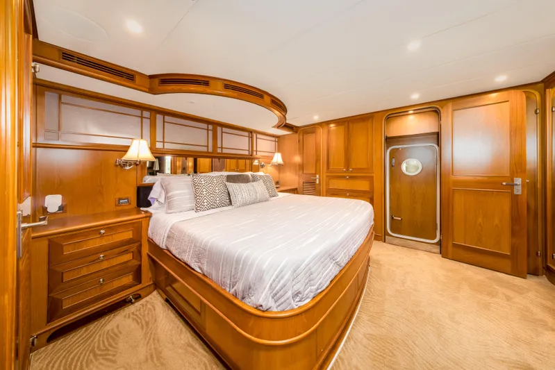 Journey Yacht Photos Pics Luxurious bedroom interior of 2008 Outer Reef Yachts 650 Motoryacht with elegant wood finish.