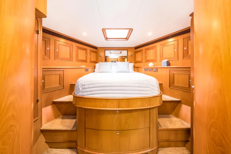 Journey Yacht Photos Pics Luxurious 2008 Outer Reef Yachts 650 Motoryacht bedroom with elegant wood paneling and cozy bedding.