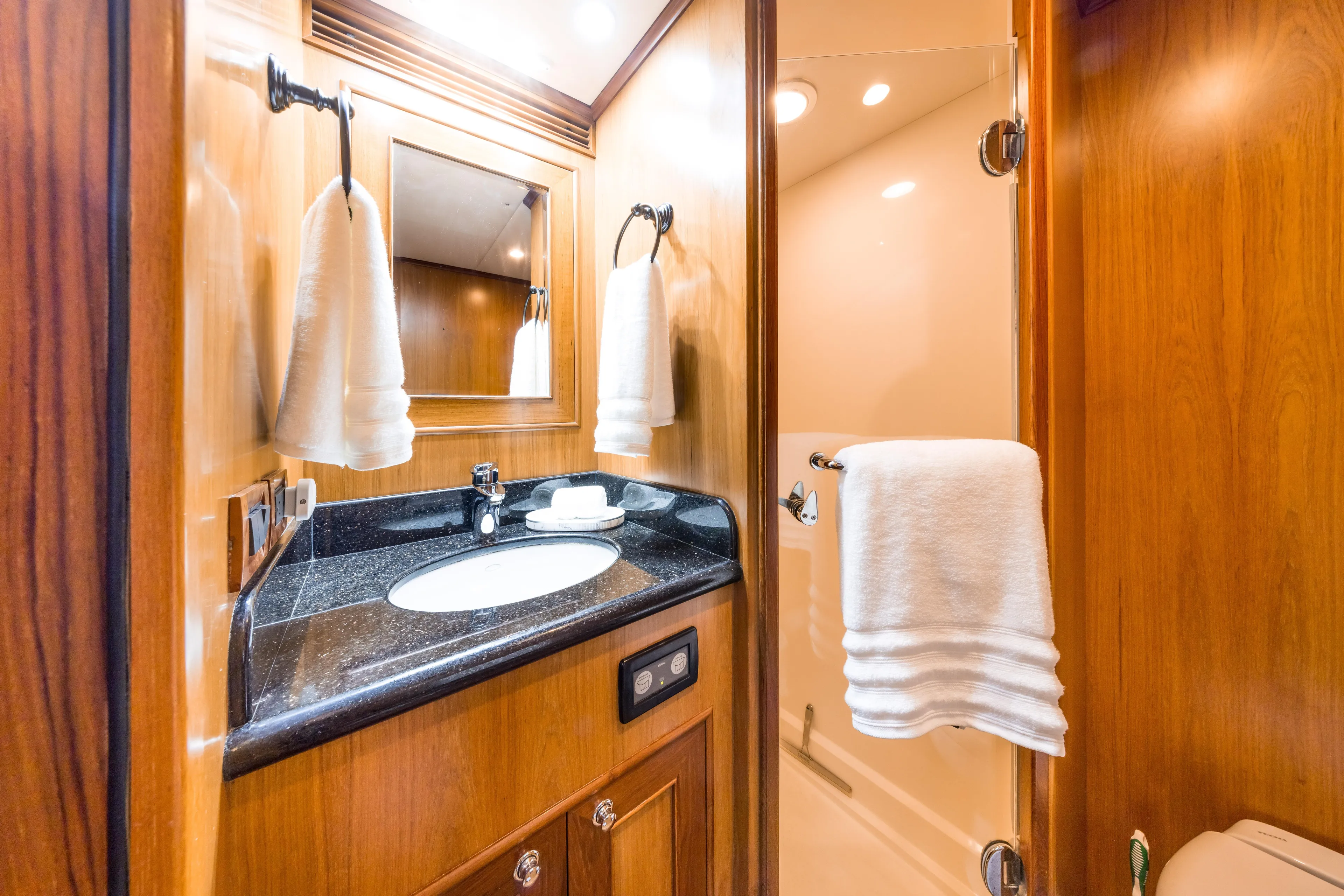 Journey Yacht Photos Pics Luxurious bathroom in 2008 Outer Reef Yachts 650 Motoryacht with wood accents and modern fixtures.