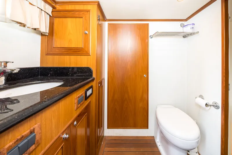 Journey Yacht Photos Pics Luxurious bathroom in 2008 Outer Reef Yachts 650 Motoryacht with wood cabinetry and modern fixtures.
