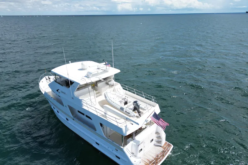 Journey Yacht Photos Pics 2008 Outer Reef Yachts 650 Motoryacht cruising on open sea with American flag.