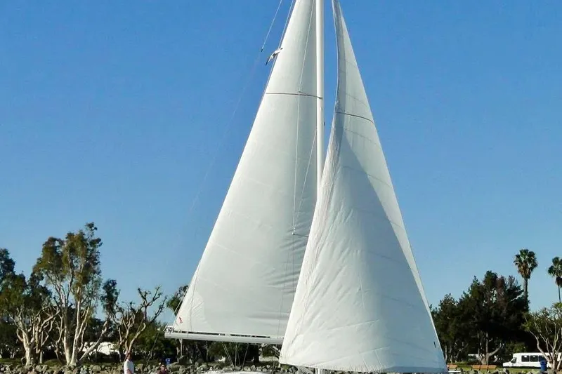 In Stock Now Yacht Photos Pics 2018 Elan 45 Impressions sailboat with white sails against a clear blue sky.