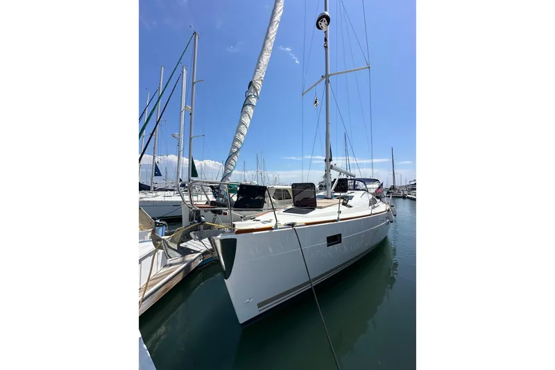 In Stock Now Yacht Photos Pics 2018 Elan 45 Impressions sailboat docked in a sunny marina.