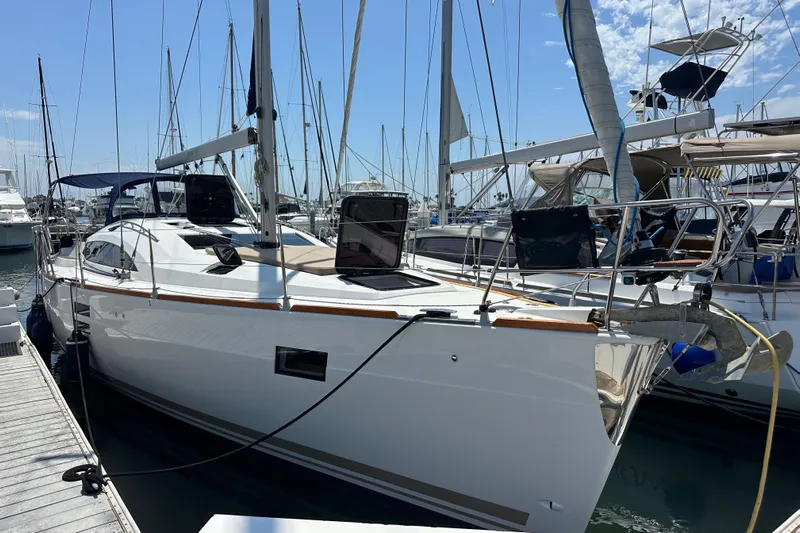In Stock Now Yacht Photos Pics 2018 Elan 45 Impressions yacht docked at a marina under a clear blue sky.
