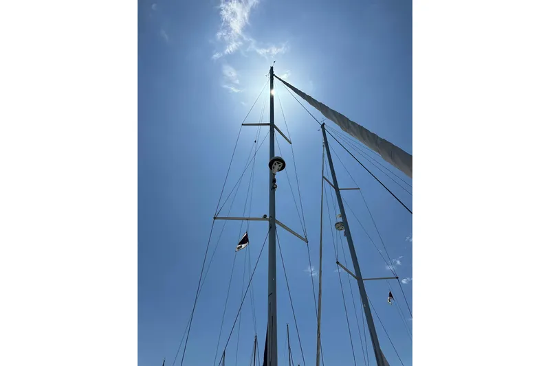 In Stock Now Yacht Photos Pics Sailboat mast of 2018 Elan 45 Impressions against a bright blue sky.