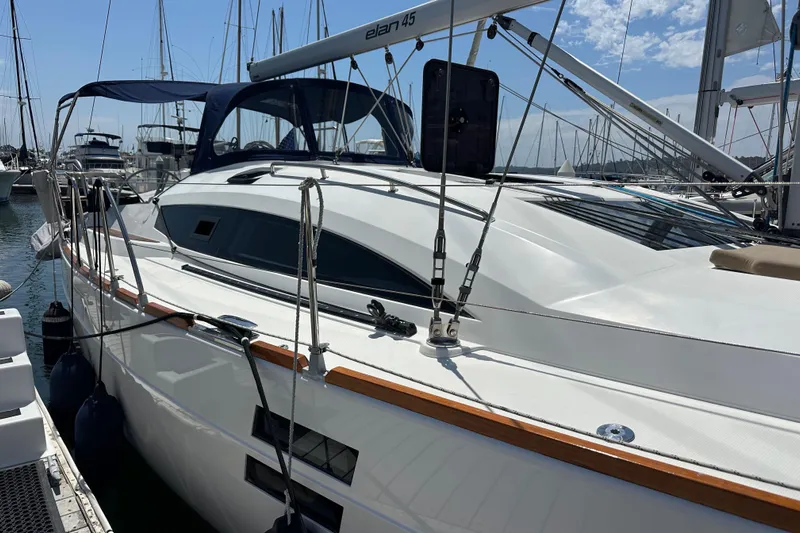 In Stock Now Yacht Photos Pics 2018 Elan 45 Impressions yacht docked in a marina under a clear blue sky.