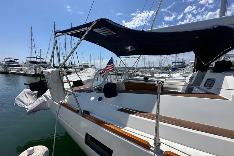 In Stock Now Yacht Photos Pics 2018 Elan 45 Impressions yacht docked at marina under clear blue sky.