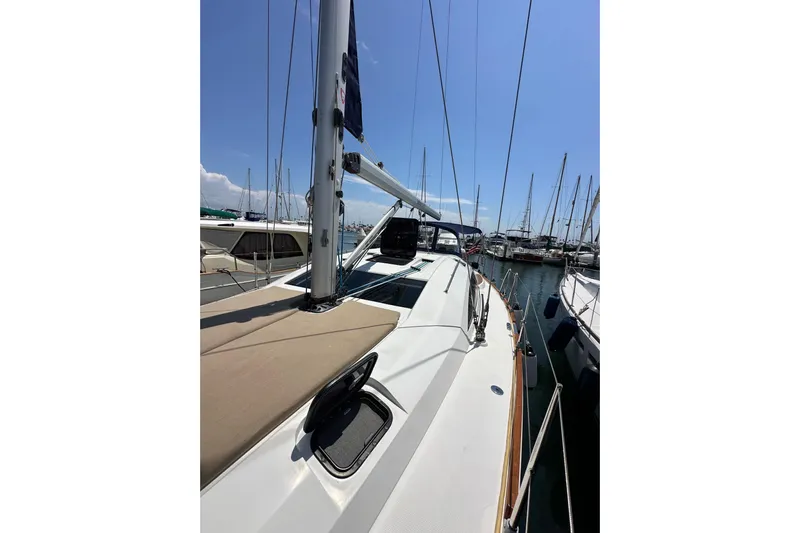 In Stock Now Yacht Photos Pics 2018 Elan 45 Impressions sailboat docked in a marina under clear blue skies.