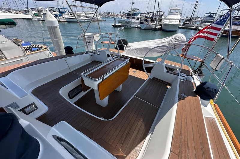 In Stock Now Yacht Photos Pics Cockpit of 2018 Elan 45 Impressions yacht docked at marina with American flag.