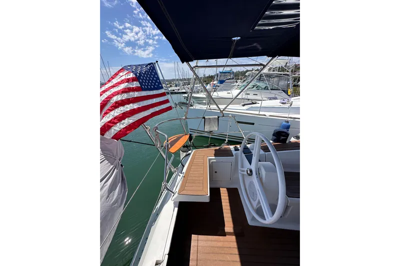 In Stock Now Yacht Photos Pics Sailing yacht Elan 45 Impressions 2018 with American flag, docked in marina.