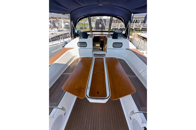 In Stock Now Yacht Photos Pics 2018 Elan 45 Impressions yacht cockpit with wooden table and seating area.