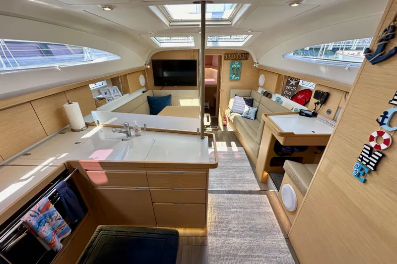 In Stock Now Yacht Photos Pics Interior of 2018 Elan 45 Impressions yacht with modern kitchen and cozy seating area.