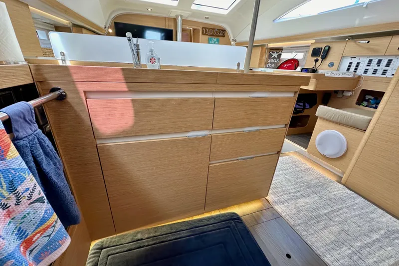 In Stock Now Yacht Photos Pics Modern kitchen interior of 2018 Elan 45 Impressions yacht with wooden cabinetry and sleek design.
