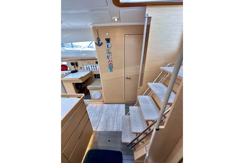 In Stock Now Yacht Photos Pics Interior of 2018 Elan 45 Impressions yacht with modern wooden design and staircase.