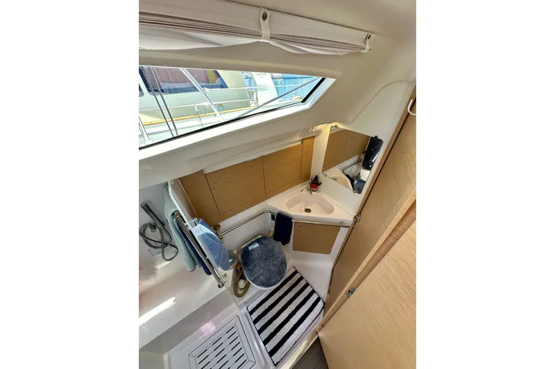 In Stock Now Yacht Photos Pics Interior of 2018 Elan 45 Impressions yacht bathroom with modern fixtures and striped rug.