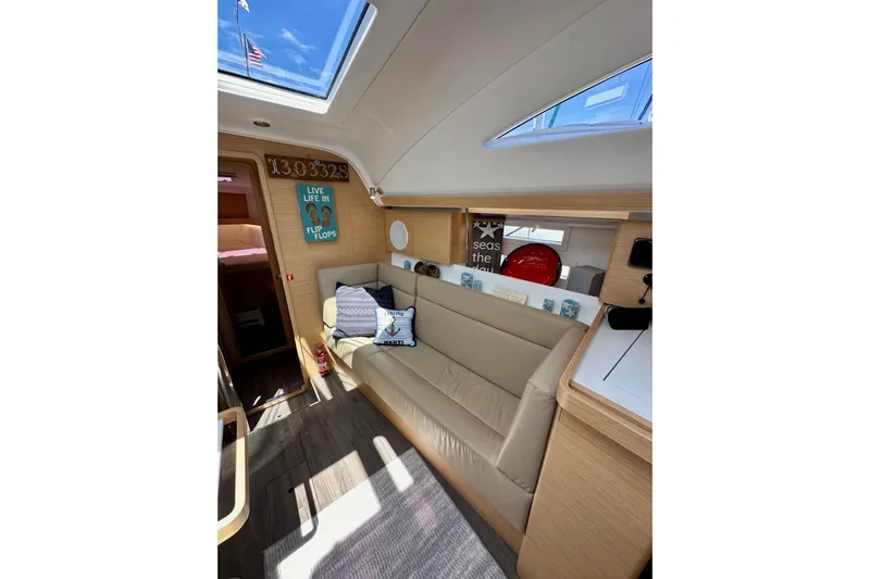 In Stock Now Yacht Photos Pics Interior of 2018 Elan 45 Impressions yacht with cozy seating and nautical decor.