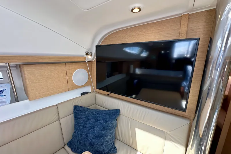 In Stock Now Yacht Photos Pics Interior of 2018 Elan 45 Impressions yacht with TV and beige seating area.