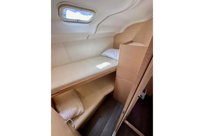 In Stock Now Yacht Photos Pics 2018 Elan 45 Impressions yacht cabin with bunk beds and natural wood finish.