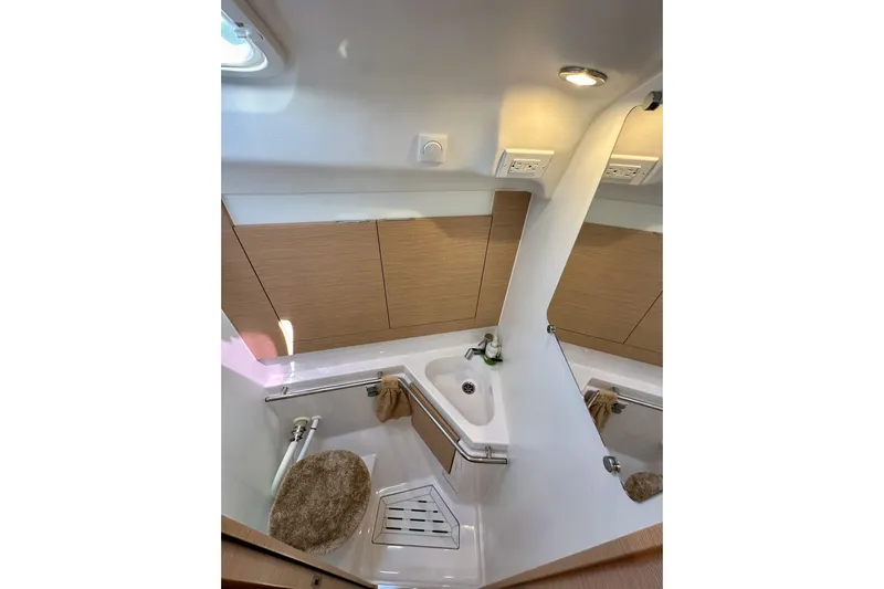 In Stock Now Yacht Photos Pics 2018 Elan 45 Impressions yacht bathroom with modern fixtures and wooden cabinetry.