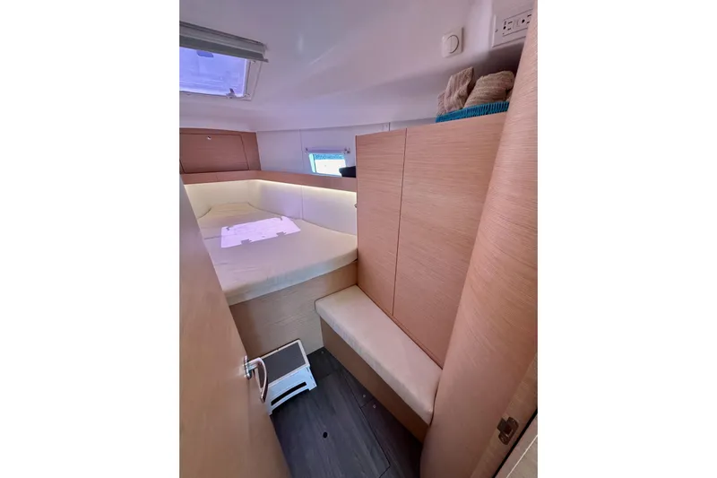 In Stock Now Yacht Photos Pics 2018 Elan 45 Impressions yacht cabin with cozy bed and wooden interior.