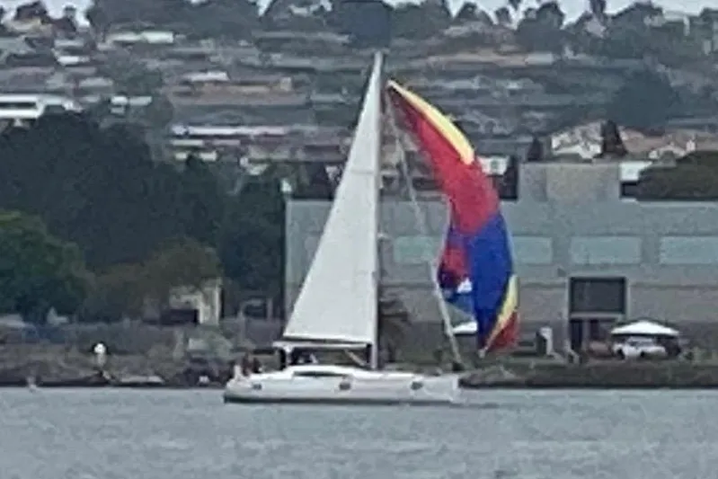 In Stock Now Yacht Photos Pics Sailboat Elan 45 Impressions 2018 with colorful spinnaker on a calm waterway.